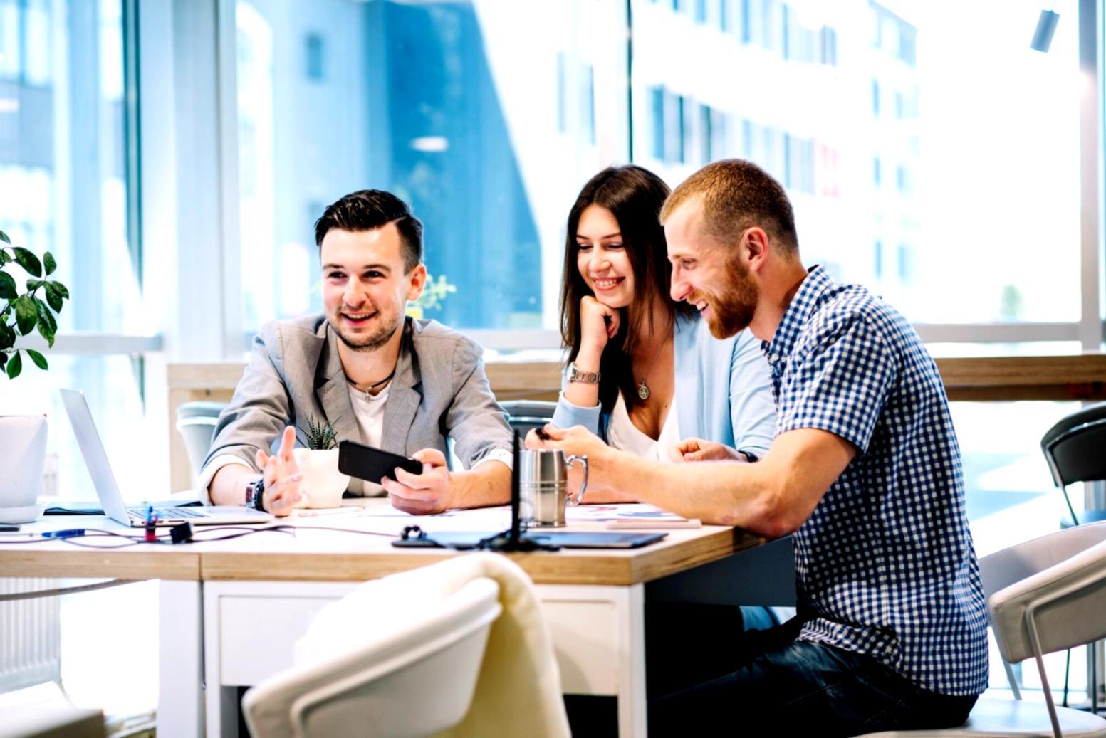 Finance professionals reviewing business strategy documents in modern office setting