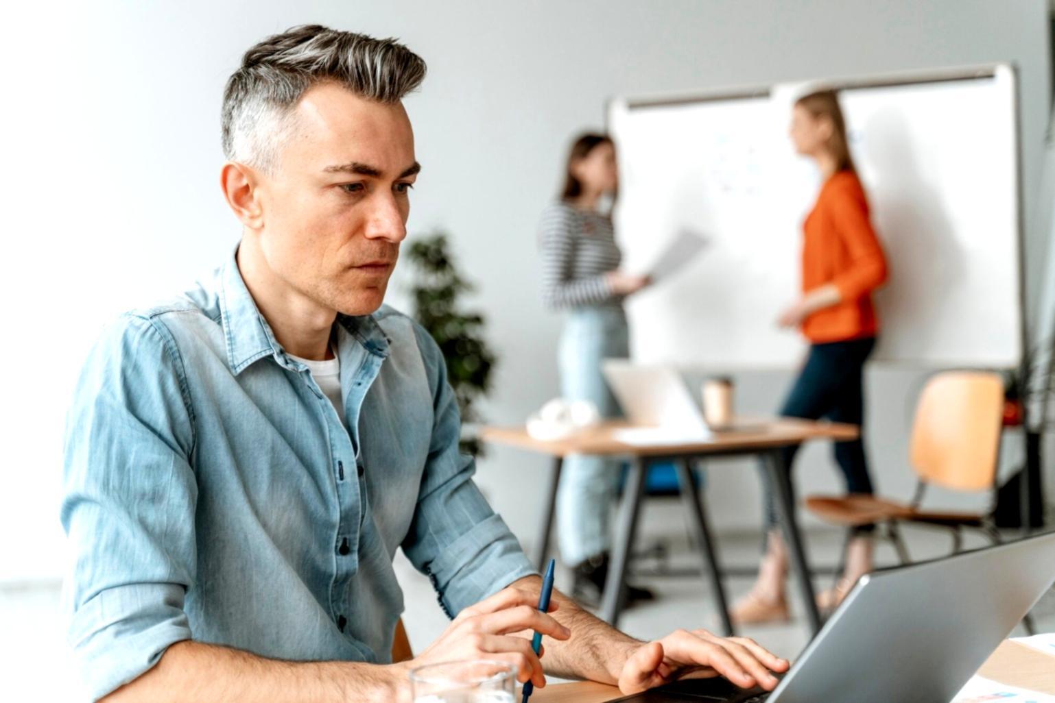 Student reviewing franchise financial materials on laptop during evening study session
